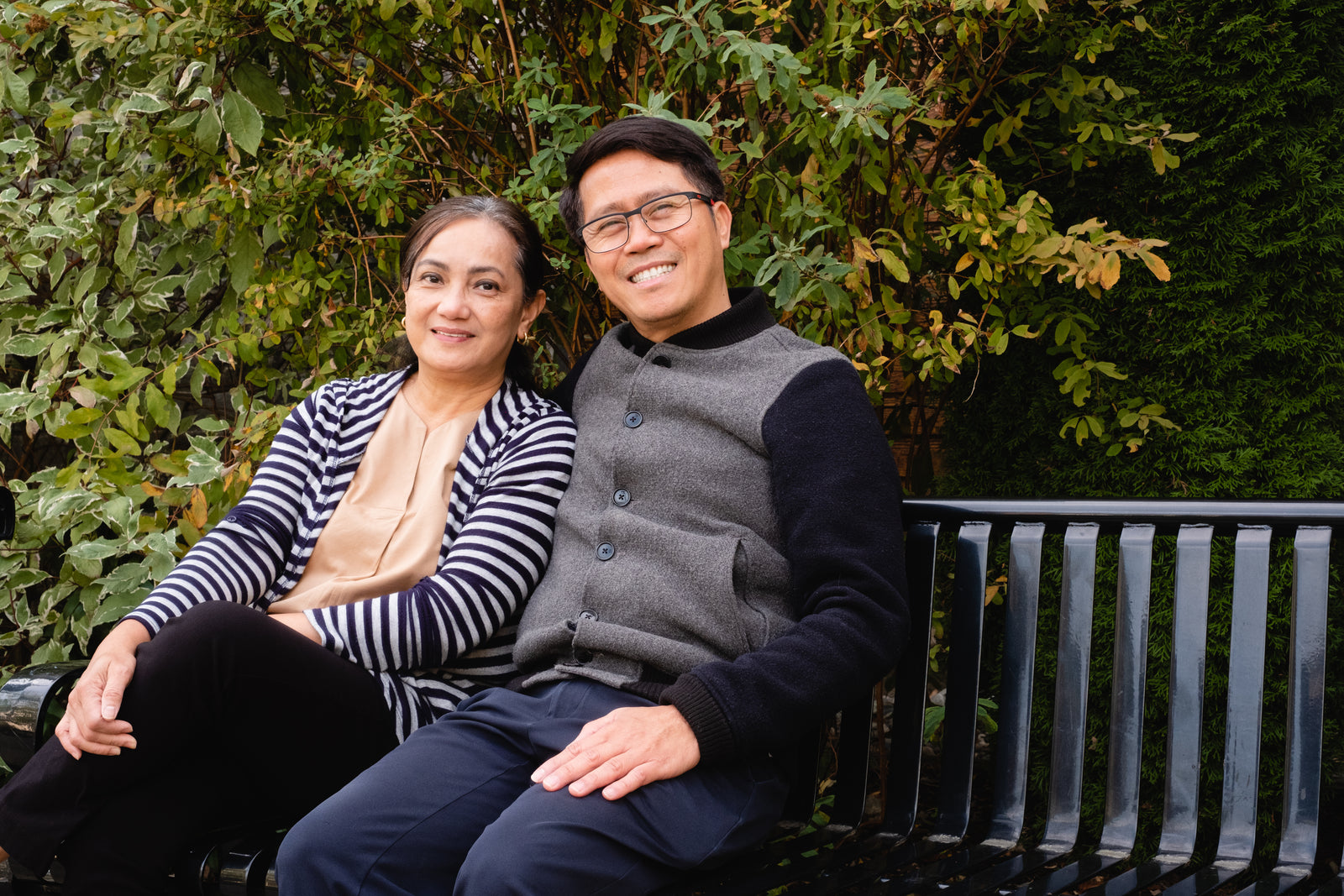 Two people sitting together on a park bench